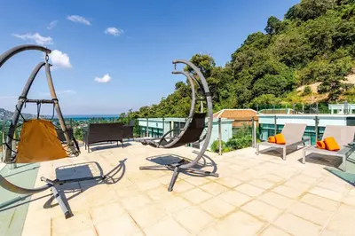 a playground with two swings and chairs on a roof at Sunny Stay A8 Charming Residence Close to Nature in Kamala Beach