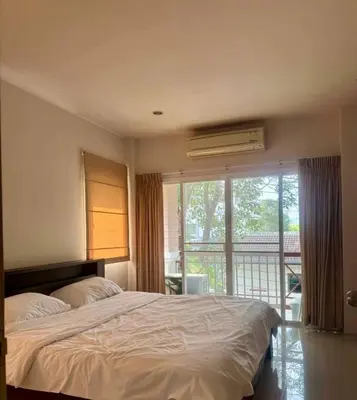 a bedroom with a bed and a large window at Дом у биг Будды in Ban Klang