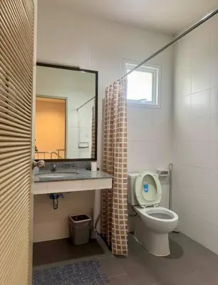 a bathroom with a toilet and a sink and a mirror at Дом у биг Будды in Ban Klang