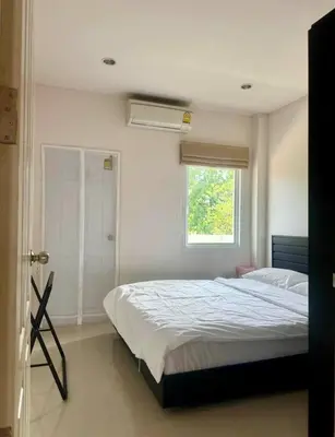 a bedroom with a large bed with a window at Дом у биг Будды in Ban Klang