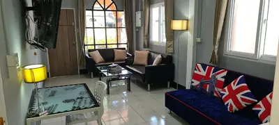 a living room with a couch and a table at Karon Homes in Karon Beach