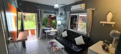 a living room with a black couch and a window at Karon Homes in Karon Beach