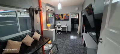 a living room with a couch and a dining room at Karon Homes in Karon Beach
