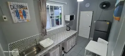 a small kitchen with a sink and a refrigerator at Karon Homes in Karon Beach