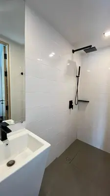 a white bathroom with a sink and a mirror at Condo Loft style pool access 001 in Rawai Beach