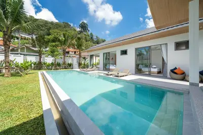 a swimming pool in the backyard of a villa at Himmapana Villas - Grand Valley in Kamala Beach