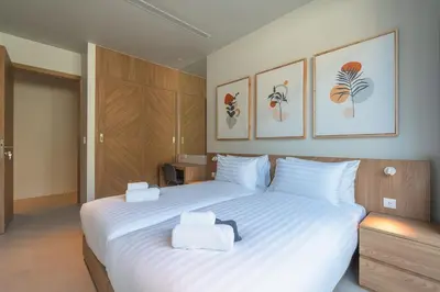 a bedroom with a large white bed with two towels on it at V157 Brand New Beautiful Dream Villa in Kamala Beach