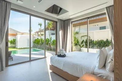 a bedroom with a large bed and a pool at V157 Brand New Beautiful Dream Villa in Kamala Beach