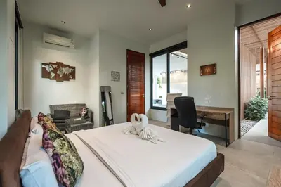 a bedroom with a bed and a desk and a table at V158 9BR Tennis On prestigious Phuket Country Club in Kathu