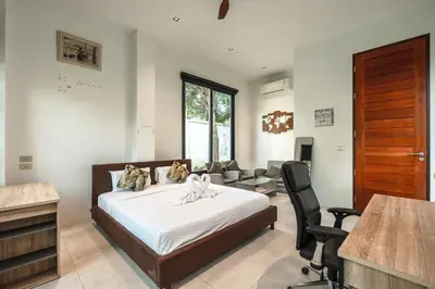 a bedroom with a bed and a living room at V158 9BR Tennis On prestigious Phuket Country Club in Kathu