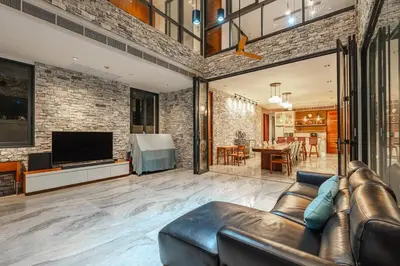 a living room with a leather couch and a television at V158 9BR Tennis On prestigious Phuket Country Club in Kathu