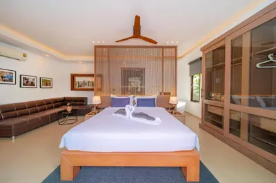 a bedroom with a large bed and a couch at kamala 1000 sqm new luxury 4 bedroom holiday pool villa extra large space amazing sunset in Kamala Beach
