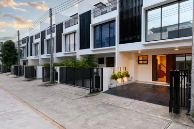 an apartment building with a black fence at Spacious 3bd Townhouse in Laguna park in Laguna Phuket