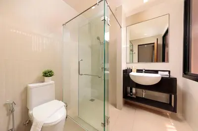 a bathroom with a shower and a toilet and a sink at Spacious 3bd Townhouse in Laguna park in Laguna Phuket