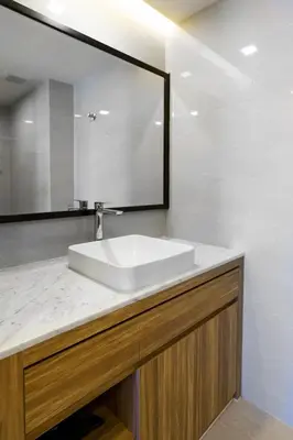a bathroom with a white sink and a mirror at Lovely studio 5 stars Hotel La Vita in Phuket Town