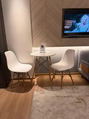 two white chairs and a table in a room at Lovely studio 5 stars Hotel La Vita in Phuket Town