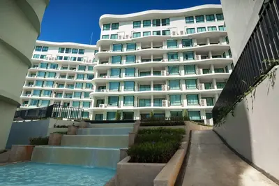 a large white building with stairs in front of a building at Lovely studio 5 stars Hotel La Vita in Phuket Town