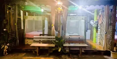 a room with two benches and a bed in it at Nu Bamboo Backpacker in Phuket