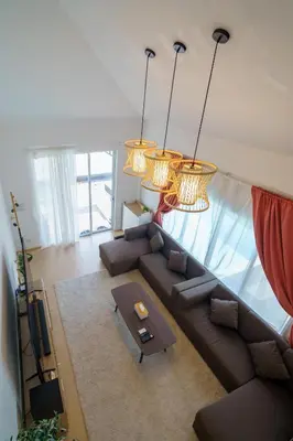 a living room with a couch and a table at 4BR Pool Villa Sukhum in Phuket Town in Changwat Phuket