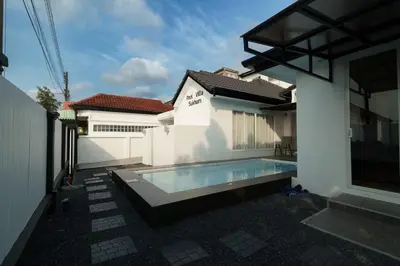 a swimming pool in the backyard of a house at 4BR Pool Villa Sukhum in Phuket Town in Changwat Phuket