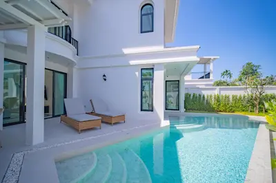a villa with a swimming pool and a house at Fifth Element Pool Villas by NLA in Bang Tao Beach