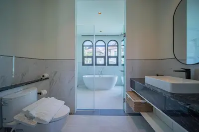a bathroom with a toilet and a sink and a tub at Fifth Element Pool Villas by NLA in Bang Tao Beach