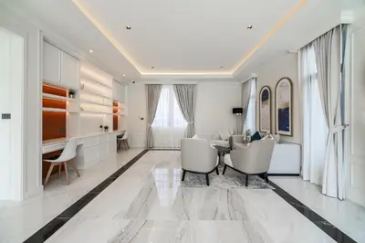 a white living room with a table and chairs at Fifth Element Pool Villas by NLA in Bang Tao Beach