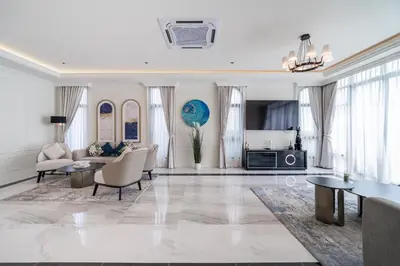 a living room with a couch and a table at Fifth Element Pool Villas by NLA in Bang Tao Beach