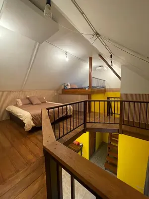 a bedroom with a bed and a staircase in it at Baibon3 Homestay Thalang Phuket in Ban Na Nai