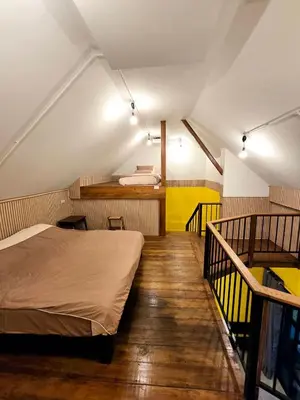 a bedroom with a bed and stairs in a room at Baibon3 Homestay Thalang Phuket in Ban Na Nai