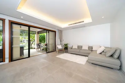 a living room with a couch and a table at Angsana Laguna Phuket 2- bedroom, with pool access in Layan Beach