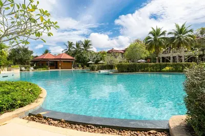 a large swimming pool with blue water in a yard at Angsana Laguna Phuket 2- bedroom, with pool access in Layan Beach