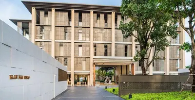 an external view of a building with a tree at Baan Mai Khao Condo Phuket for rent in Phuket