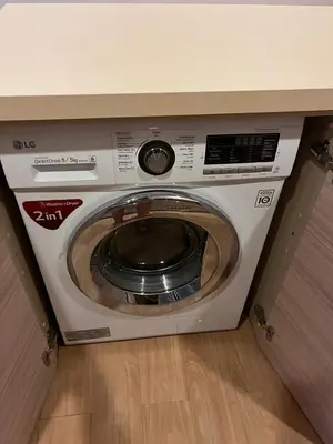 a washing machine sitting under a counter at Baan Mai Khao Condo Phuket for rent in Phuket