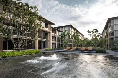 a courtyard with a fountain with chairs and buildings at Baan Mai Khao Condo Phuket for rent in Phuket