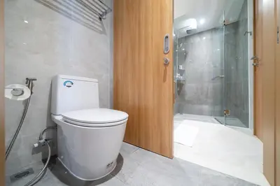 a bathroom with a toilet and a shower at Laguna Beachside Residents in Phuket