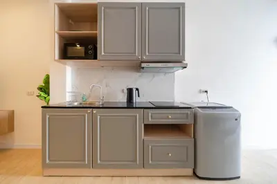 a kitchen with a sink and a refrigerator at Winks Beach Patong Phuket in Patong Beach
