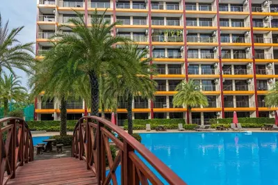 a hotel with a pool in front of a building at 1 BR studio 777 Beach Condotel in Mai Khao Beach