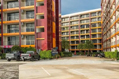 a parking lot in front of a large building at 1 BR studio 777 Beach Condotel in Mai Khao Beach