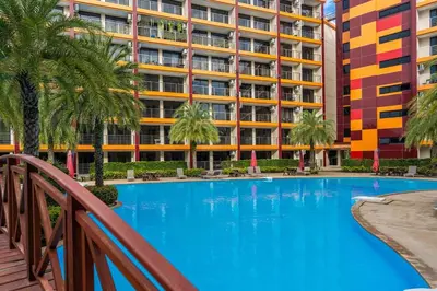 a swimming pool in front of a building at 1 BR studio 777 Beach Condotel in Mai Khao Beach