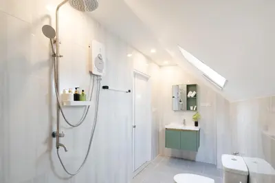 a bathroom with a shower and a toilet and a sink at Winks House Patong Phuket 4B in Patong Beach