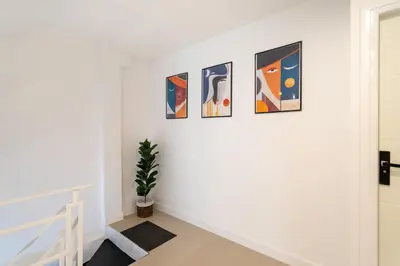 a hallway with four paintings on a wall at Winks House Patong Phuket 4B in Patong Beach