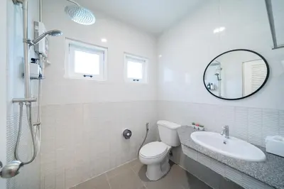 a bathroom with a toilet and a sink and a mirror at 4BR villa W Jacuzzi Heart of Patong in Patong Beach