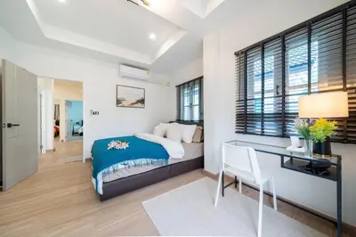 a bedroom with a bed and a desk at 4BR villa W Jacuzzi Heart of Patong in Patong Beach