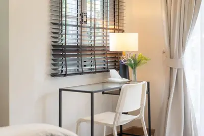 a desk with a chair and a lamp in a room at 4BR villa W Jacuzzi Heart of Patong in Patong Beach