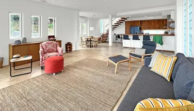 a living room with a couch and chairs and a kitchen at At the Beach New 6-9 person Pool Villa Ao Yon Phuket in Ko Thanan