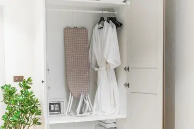 a white closet with white clothes and a mirror at Title Halo 1st Floor Naiyang Pool Gym 2BR in Nai Yang Beach