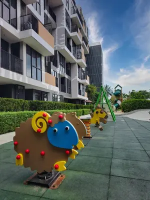 a row of playground equipment in front of a building at 1BDR Laguna 10 min to the Sea Roof Pool in Laguna Phuket