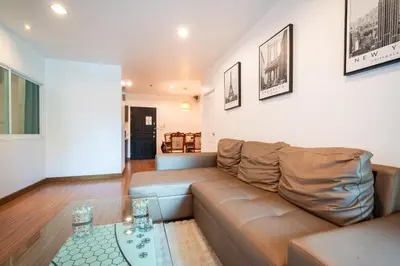 a living room with a couch and a glass table at \u82ad\u4e1c 19243 \u4e24\u5367\u6cf3\u6c60\u516c\u5bd3 \u8fd1Bangla \u73ed\u8d5e\u591c\u5e02 \u6c5f\u897f\u51b7\u8d2d\u7269\u5546\u573a in Patong Beach