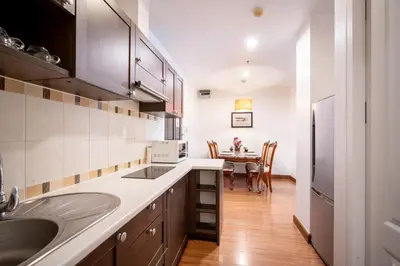 a kitchen with a sink and a table with chairs at \u82ad\u4e1c 19243 \u4e24\u5367\u6cf3\u6c60\u516c\u5bd3 \u8fd1Bangla \u73ed\u8d5e\u591c\u5e02 \u6c5f\u897f\u51b7\u8d2d\u7269\u5546\u573a in Patong Beach